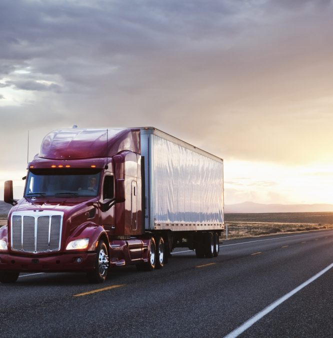 3/4 front view of a commercial truck on the road at sunset  in eastern Washington, USA